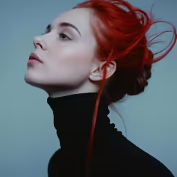 a woman with red hair wearing a black turtle neck top