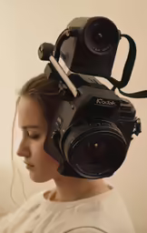 a woman wearing headphones is holding a camera