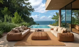 a big living room with some big couches by the water