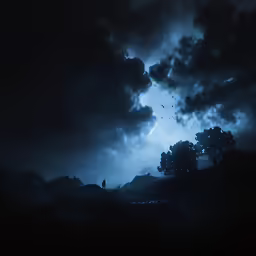 clouds that are very dark over some hills