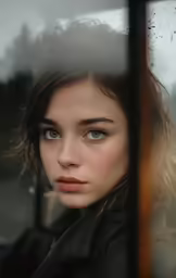 a girl is seen looking out the window of a vehicle