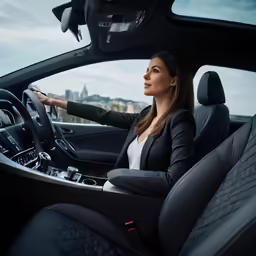 a woman in the drivers seat of a car