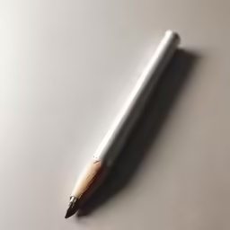 a closeup of a pen sitting on a table