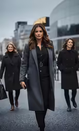 the pretty woman in grey coat and black pants