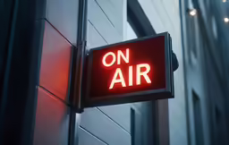 a red sign sitting on the side of a building