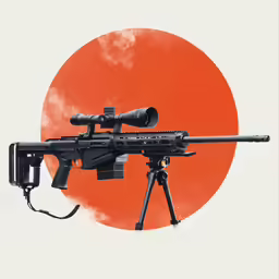 a machine gun that has an orange and black circle in the background