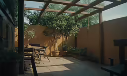 a patio with a table and chairs is shown