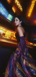 a woman in a purple dress walking through an airport