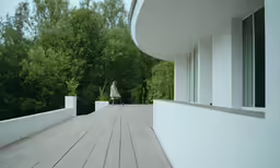 the person walks down the boardwalk outside of a house