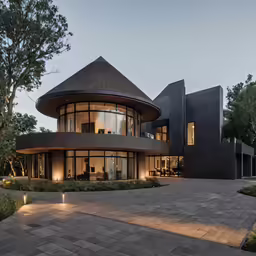 a modern style house surrounded by trees at dusk