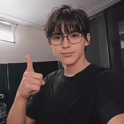a young boy is giving a thumbs up