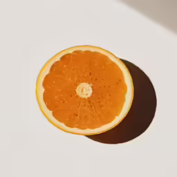 an orange cut in half and placed on a table