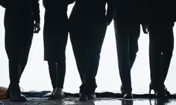 a line of five people standing next to each other