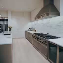 a large kitchen with all white counter tops and an oven