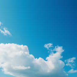 the airplane is flying high in the cloudy sky