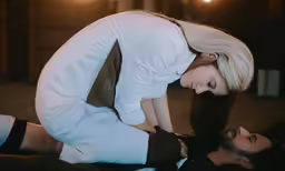 a woman is on her stomach while holding another woman