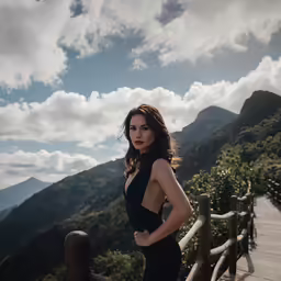 a woman is standing on a wooden walkway
