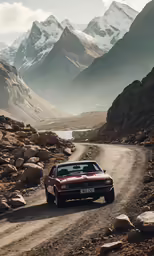 the car is driving down the road with mountains around