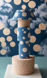 a blue sculpture with polka dots on it