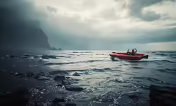 three people on a small red boat in the water