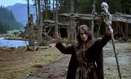 a woman holding a giant cross in her hand