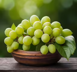 a bowl of grapes on top of a table