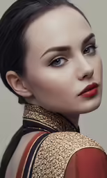 a woman with dark hair wearing a red top