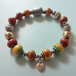 a bracelet has an ornate heart and beads,this bracelet has many colorful beads, charms and a heart charm