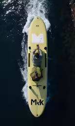 there is a man riding in a yellow boat