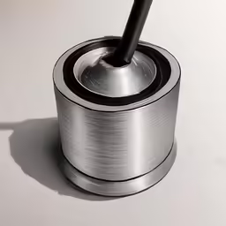 a metal object sitting on top of a white counter