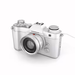 a small silver camera with a white background