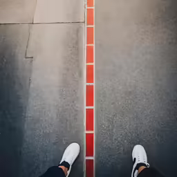 a person in white sneakers on a street
