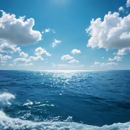 a blue ocean with a few clouds over the water