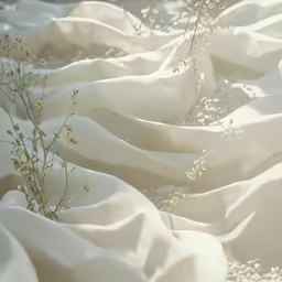 a white cloth covered with flowers and rocks