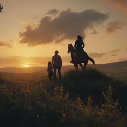 a family watches the sun set on a hilltop