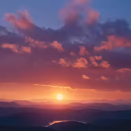 a person stands on a hill top at sunset with the sun behind a cloud