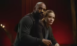 two people posing together on a stage