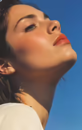 a young woman with brown hair and an orange lip