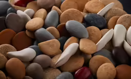 some very cute rocks with white, grey, and red pebbles