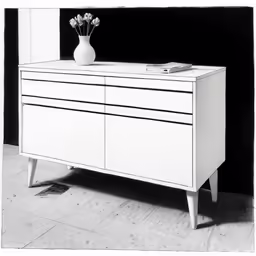 an all white dresser with some flowers in a vase