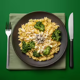 a dish of pasta and broccoli with a fork