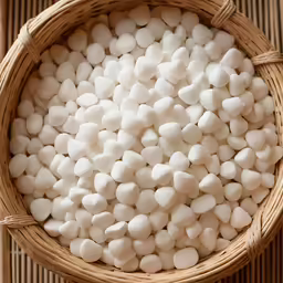 a basket filled with white chocolate next to a bamboo floor