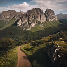 a dirt path runs between two mountains on top of the hill