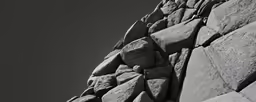 a rock is seen against a black and white sky