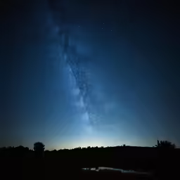 the milky shines brightly in the night sky as it passes