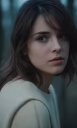 a woman with blue eyes and long hair in the woods