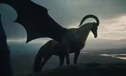 two horses and a dragon standing on top of a hillside