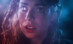 a young girl looks to her left as she appears shocked