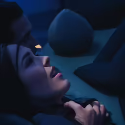 a man and a woman looking at something on the ground
