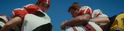 two male football players with helmets on their bodies